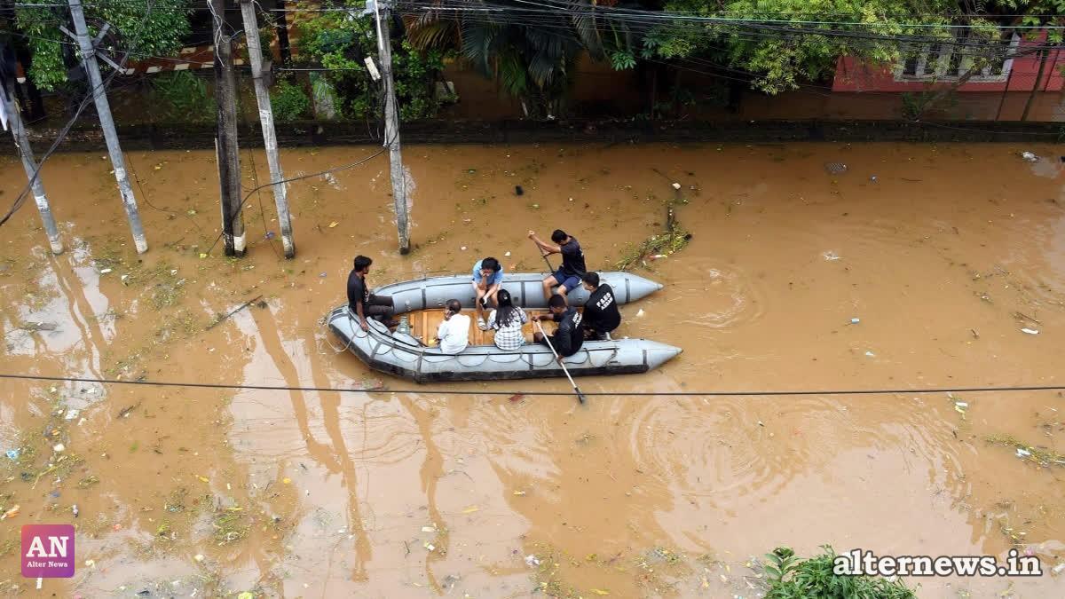 Assam Fire and Emergency Services personnel rescue people on a rubber boat from the waterlogged Anil Nagar area following heavy rainfall, in Guwahati on Sunday. (ANI)