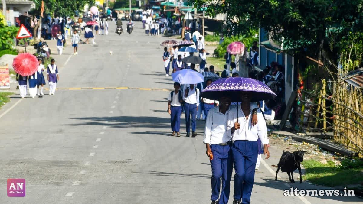 Students carry umbrellas as they make their way home from school amid an intense heatwave in the Dooars region of Jalpaiguri district, West Bengal, on Friday, July 31, 2026. (IANS)