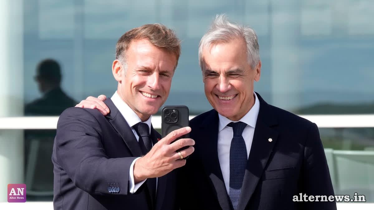 French President Emmanuel Macron, left, takes a selfie with Canadian Prime Minister Mark Carney after delivering remarks in Saint-Pierre, Saint-Pierre-et-Miquelon, Sunday (AP)